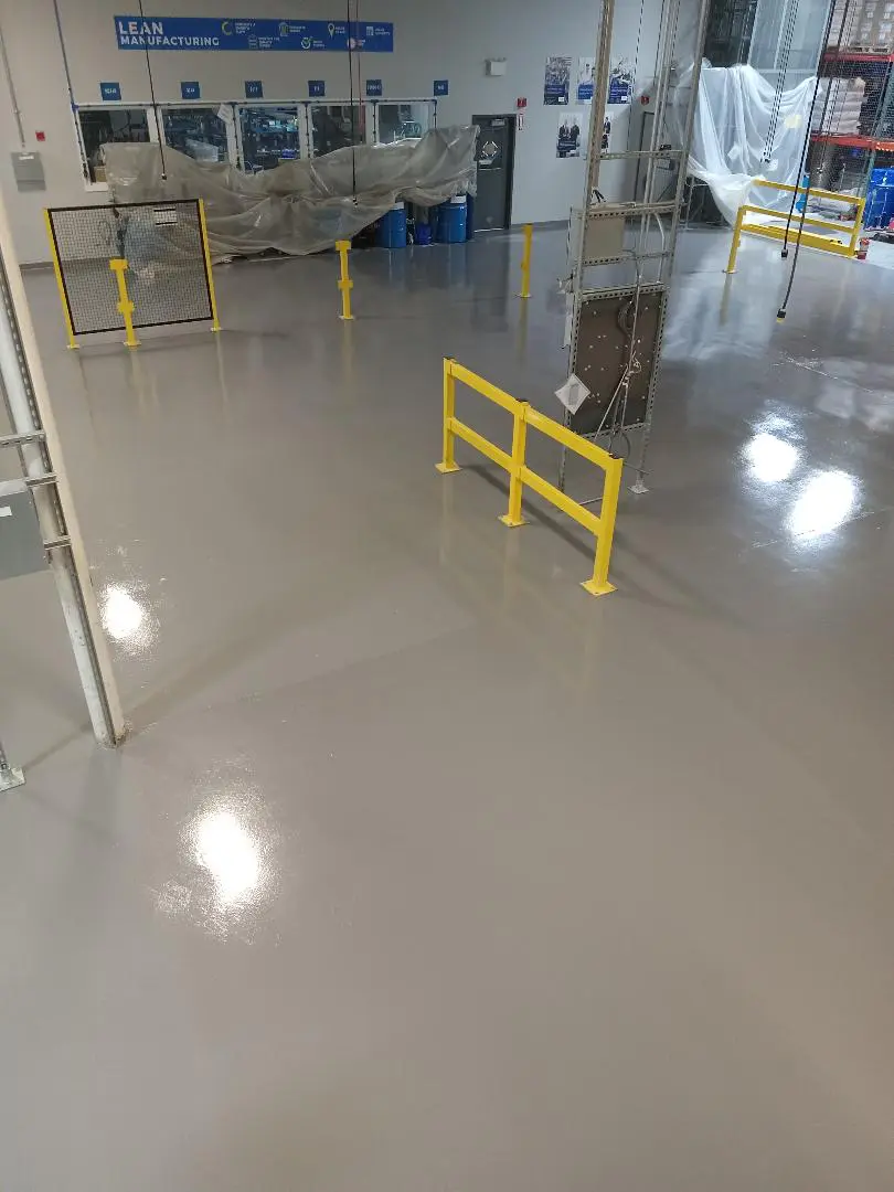 A yellow railing in the middle of a room.