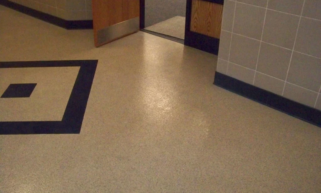 A bathroom with a door open and the floor.