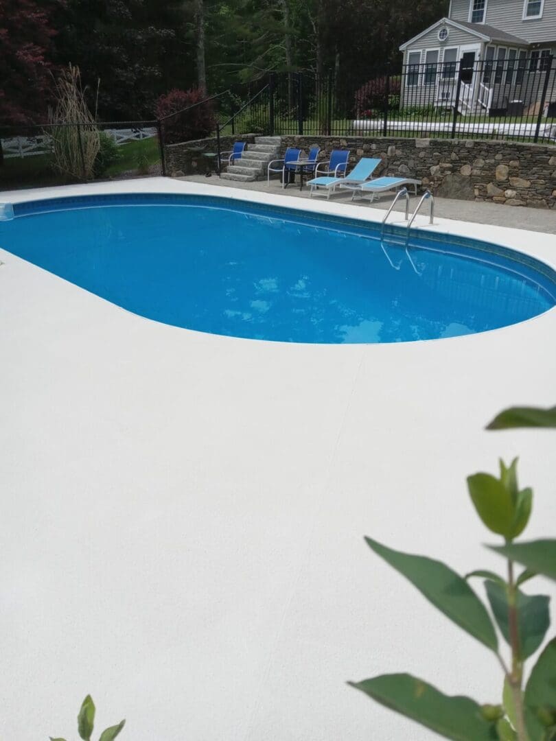 A pool with blue water and white cement.