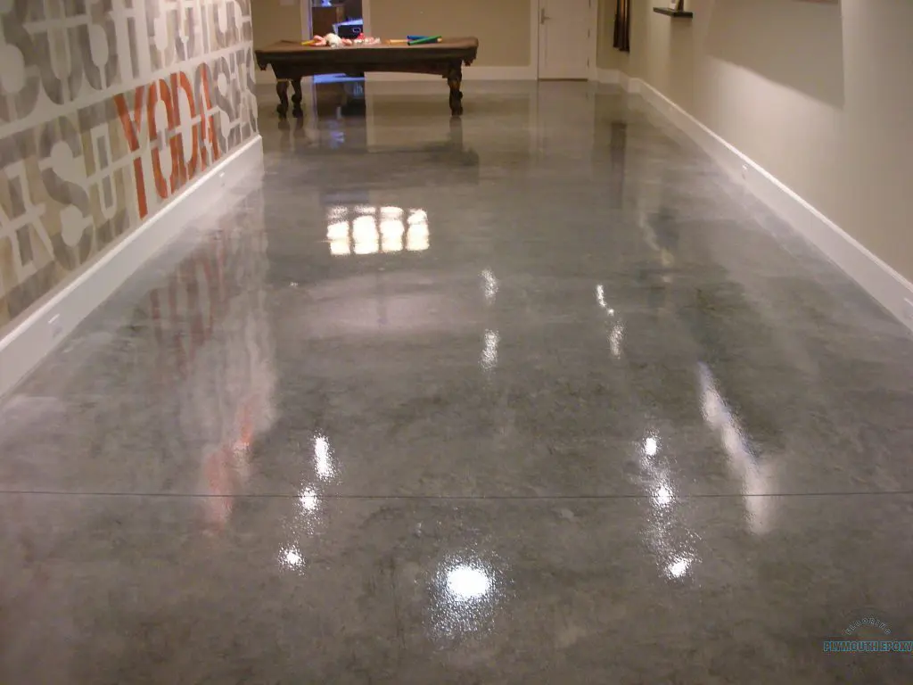 A hallway with a table and chairs in the background.